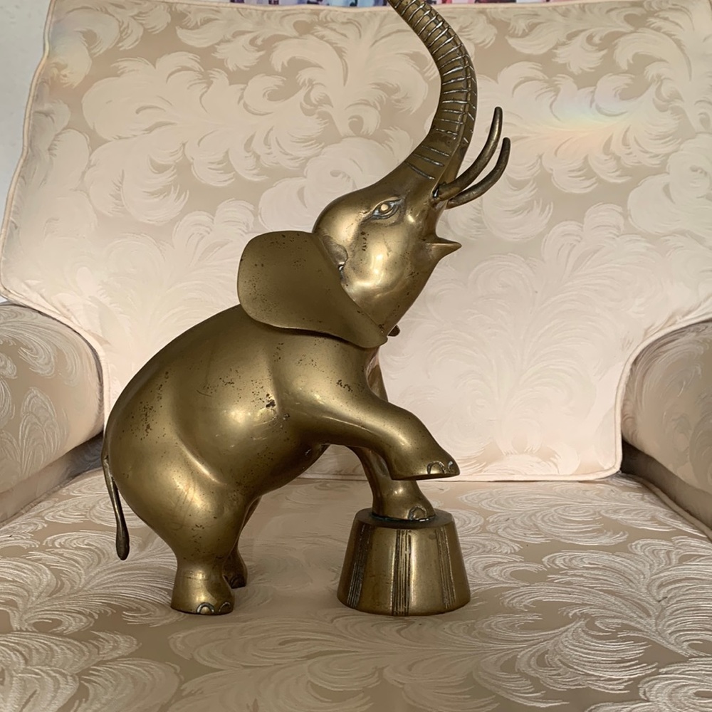 Brass elephant standing on. Oh no small drum.